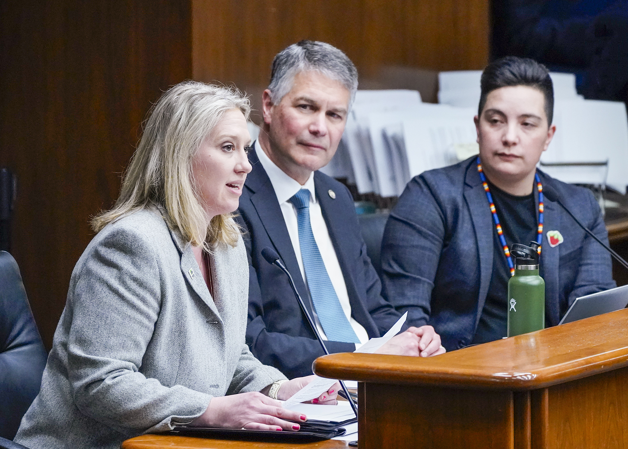 Cristen Incitti, president and CEO of Habitat for Humanity Minnesota, testifies in support of a bill that would establish minimum allowable densities on residential lots in cities. Rep. Larry Kraft, center, is the bill sponsor. (Photo by Andrew VonBank)